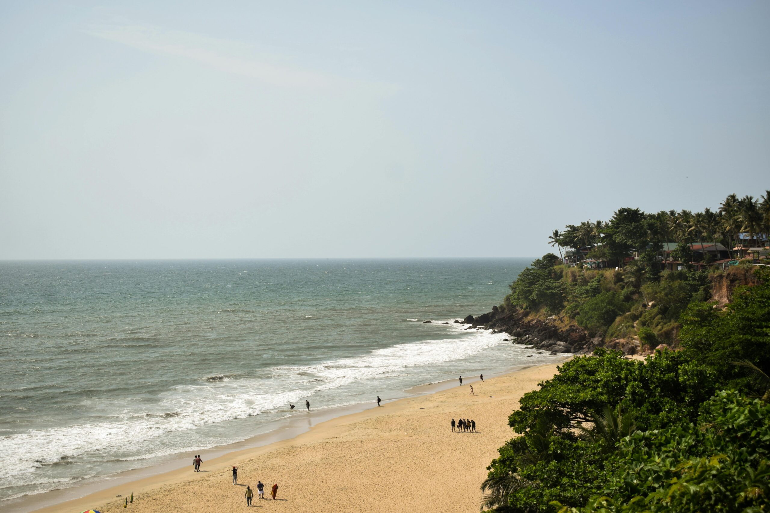Enjoy the tranquil beauty of Varkala Beach, Kerala's stunning coastline with golden sands and lush greenery.